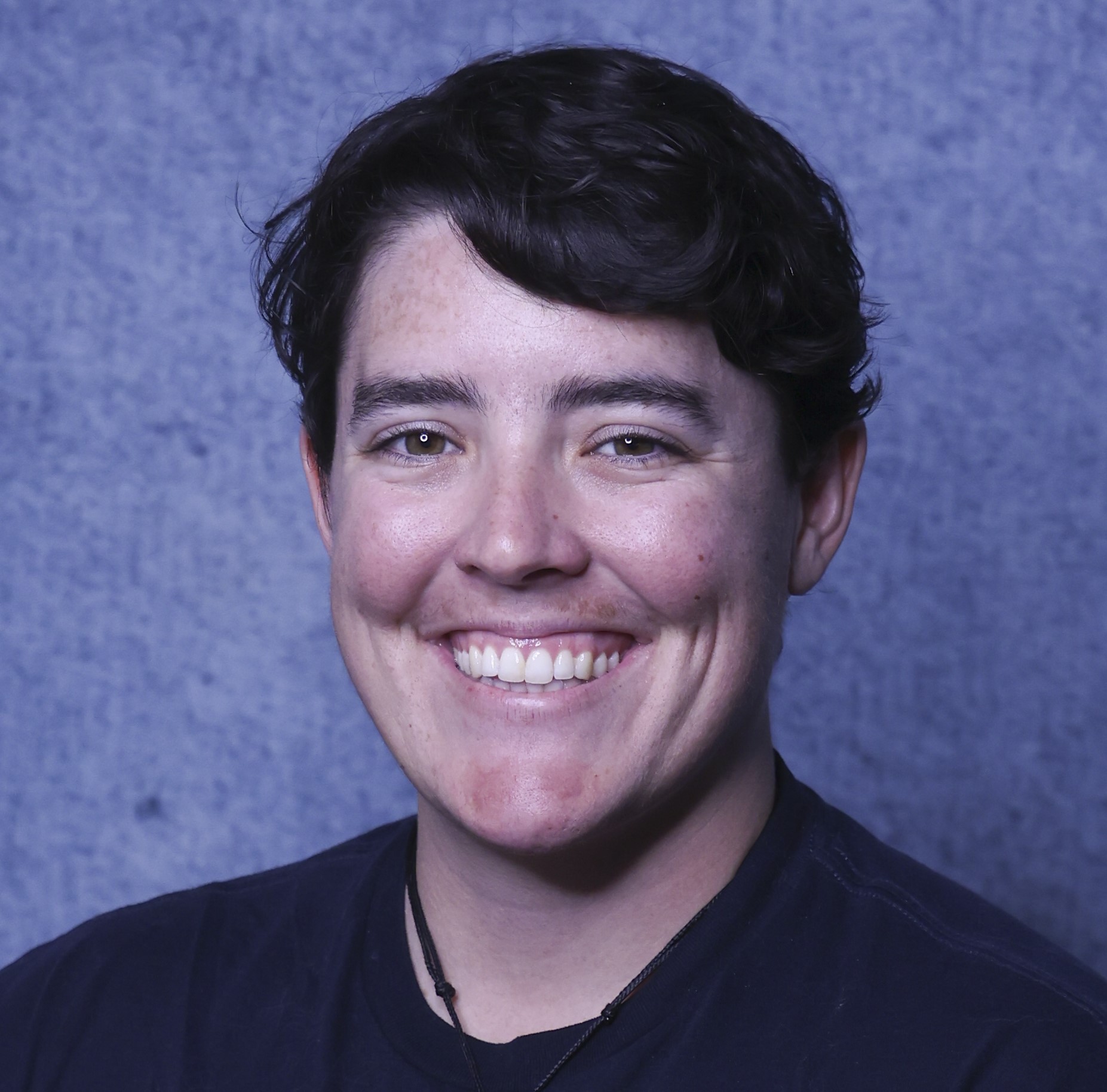 Greg Siering poses for a headshot. He wears a blazer and tie.